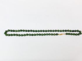 A dark green jade necklace, bead size 8mm, necklace L. 56mm.