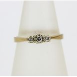 A hallmarked 9ct yellow gold diamond set ring, (M).