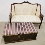 A floral upholstered carved mahogany settee on castors, together with an upholstered ottoman with