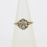A hallmarked 9ct yellow gold diamond cluster ring, (N.5).