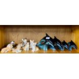 A group of Russian porcelain animal figures with a set of four Poole pottery dolphins, tallest