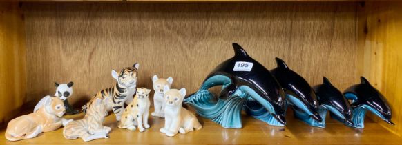 A group of Russian porcelain animal figures with a set of four Poole pottery dolphins, tallest