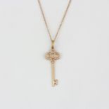 A boxed 18ct rose gold Tiffany and Co diamond set key shaped pendant and chain, pendant L. 3.2cm.