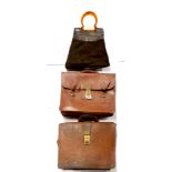 A vintage leather and suede handbag with lucite handle and two leather briefcases.