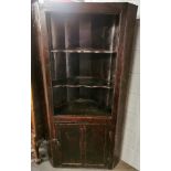 A 17th century stained pine corner cupboard, H. 174cm. W. 89cm.