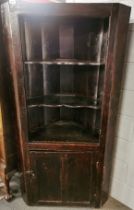 A 17th century stained pine corner cupboard, H. 174cm. W. 89cm.