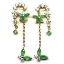 A pair of gold on 925 silver long drop earrings set with marquise cut emeralds and white stones,