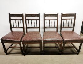 A set of four carved and turned mahogany upholstered dining chairs.