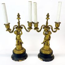 A pair of 19th century gilt bronze cherub candelabra converted for use as table lamps, H. 38cm.