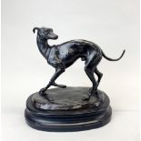 A bronze figure of a dog on a black slate base, H. 27cm.