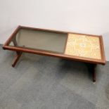 A 1960's teak G Plan style tile and glass topped coffee table, 120 x 50 x 44cm.
