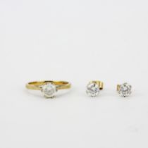 A hallmarked 9ct yellow gold stone set solitaire ring, (L.5), with a matching pair of earrings.