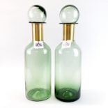 A pair of large green glass and gilt metal factice window display bottles, H. 53cm.