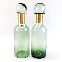 A pair of large green glass and gilt metal factice window display bottles, H. 53cm.