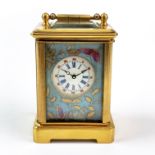 A miniature gilt brass and porcelain carriage clock, H. 7.5cm.