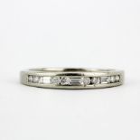 A 9ct white gold ring set with baguette and brilliant cut diamonds, (N).