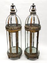 A pair of large gilt metal and glass storm lanterns, H. 80cm.