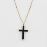 An 18ct yellow gold and carved wooden cross pendant, on an 18ct yellow gold chain, L. 51cm.