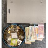 A filing drawer and tin of mixed coins and bank notes.