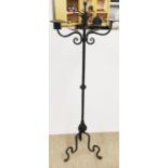 A floor standing wrought iron candle holder, H. 149cm W. 50cm.