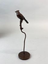 A small Chinese bronze model of a bird on a perch, H. 16.5cm.
