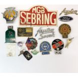 A collection of mixed vintage car badges etc. including Cambridge University, Austin seven, MGB