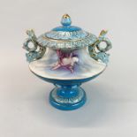 A continental porcelain jar and cover with dolphin handles and cherub decoration, H. 24cm.