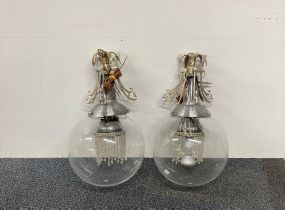 Two matching globe shaped plastic and metal ceiling lights.