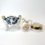 An early soft paste porcelain cup and saucer together with a German porcelain cream jug and a German