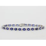 An 18ct white gold bracelet set with oval cut sapphires and diamonds, diamond approx. 0.61ct