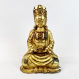 A Sino-Tibetan gilt bronze figure of a seated deity, H. 21cm.