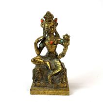 A Sino-Tibetan gilt bronze figure of a seated a deity, H. 14cm.