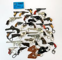 A collection of miniature gun keyrings etc.