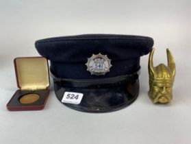 A vintage Ford security cap with a Ford bronze 30 year token and brass paperweight.