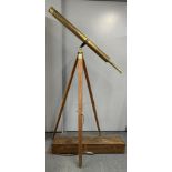 A large Victorian gilt brass telescope, closed L. 100cm, with associated but later tripod in brass