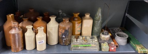 A group of stoneware bottles and other items.