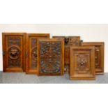 Six antique carved wooden panels and doors, largest 37 x 64cm.