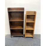 Two small oak bookcases together two standard lamps.