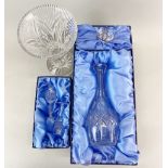 A boxed Waterford crystal decanter with two Waterford crystal sherry glasses and a Waterford vase.