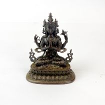 A small very detailed Tibetan bronze figure a seated Tara, H. 10cm.