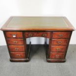 A stained oak and leather topped knee-hole writing desk with an interesting hidden drawer, 115 x