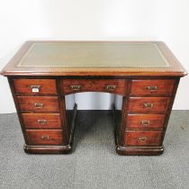 A stained oak and leather topped knee-hole writing desk with an interesting hidden drawer, 115 x