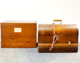 A cased Singer sewing machine and a wooden box containing sheet music.