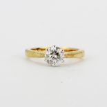 An 18ct yellow gold solitaire ring set with a brilliant cut diamond, (K.5).