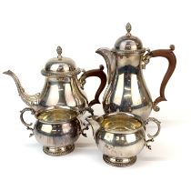 A heavy hallmarked silver four-piece tea set with Bakelite handles.