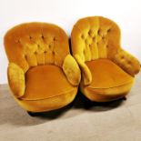 A pair of yellow button backed armchairs on castors, H. 85cm.