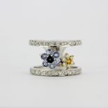 A heavy 18ct white gold ring set with diamonds, fancy yellow diamonds and sapphires, (N).