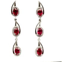 A pair of 925 silver drop earrings set with oval cut rubies and white stones, L. 4.5cm.