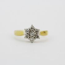 An 18ct yellow gold diamond set daisy cluster ring, approx. 0.75ct total, (L).