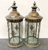 A pair of gilt metal and glass garden storm lanterns, H. 56cm.